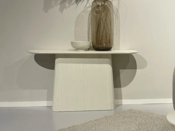 Beige side table with chic, stylish look. This trendy wall table features rounded sides centre leg.