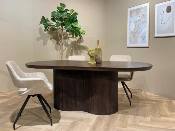Dark brown dining table with a wavy slat base. This table features a rounded top, trendy separate wavy leg.